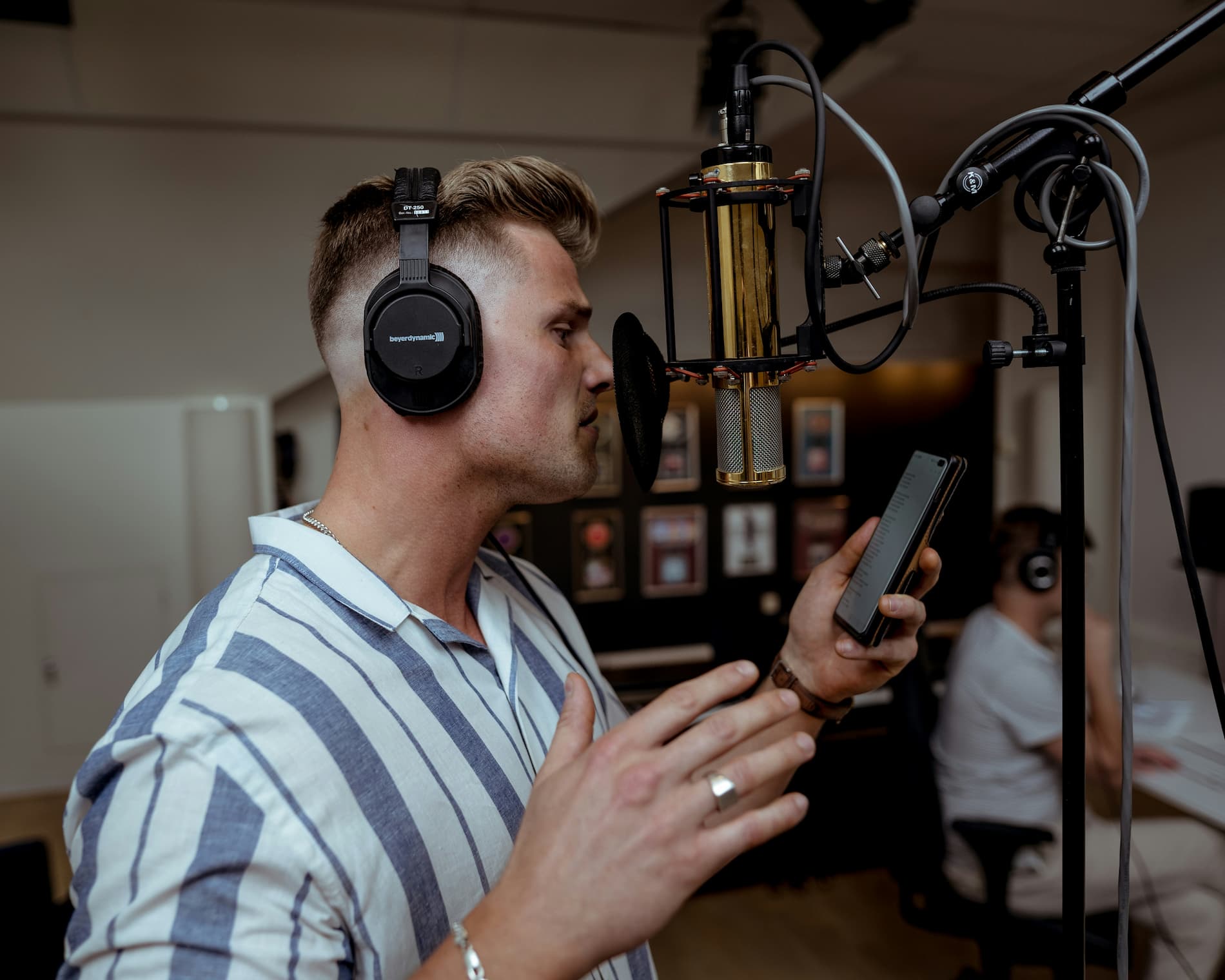 Female voice artist at the microphone in a recording studio